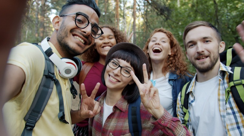 A diverse group of friends taking a selfie outdoors